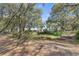 Serene property featuring a pond surrounded by lush trees at 26711 County Road 33, Groveland, FL 34736