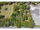 Aerial view of property with mature trees and cleared land at 26711 County Road 33, Groveland, FL 34736