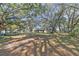 View of outbuildings on property, surrounded by mature trees at 26711 County Road 33, Groveland, FL 34736