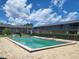 Relaxing community pool with plenty of lounge chairs and a fenced area at 1100 E Caroline St # 115, Tavares, FL 32778
