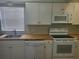 Updated kitchen with white cabinets, butcher block countertops, and appliances at 1100 E Caroline St # 115, Tavares, FL 32778