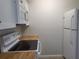 Modern kitchen with white cabinets, wood countertops, and a full suite of appliances at 1100 E Caroline St # 115, Tavares, FL 32778