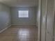Bedroom with tile floor, window, and closet at 1100 E Caroline St # 115, Tavares, FL 32778
