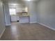 Open living room and kitchen with tile floors at 1100 E Caroline St # 115, Tavares, FL 32778