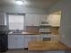 Updated kitchen with butcher block countertops and white cabinets at 1100 E Caroline St # 115, Tavares, FL 32778