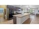 Modern kitchen with dark wood cabinets, granite countertops, and island at 9342 Oglethorpe Dr, Groveland, FL 34736