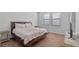 Spacious bedroom with large bed, neutral walls, and ample natural light at 9342 Oglethorpe Dr, Groveland, FL 34736