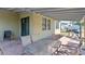Covered patio with seating area and glass-top table at 9342 Oglethorpe Dr, Groveland, FL 34736