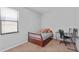Small bedroom with twin bed, workspace, and window at 9342 Oglethorpe Dr, Groveland, FL 34736