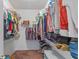 Large walk-in closet with double hanging rods and shelving at 9342 Oglethorpe Dr, Groveland, FL 34736