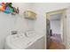 Laundry room with washer, dryer, and shelving at 9342 Oglethorpe Dr, Groveland, FL 34736