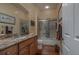 Bathroom with granite countertop and tile shower at 33 Camino Real # 303, Howey In The Hills, FL 34737