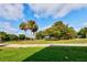 Landscaped golf course with palm trees and lush greenery at 33 Camino Real # 303, Howey In The Hills, FL 34737
