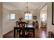 Formal dining room with hardwood floors and a charming chandelier at 33 Camino Real # 303, Howey In The Hills, FL 34737