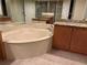 Large bathroom with corner bathtub and granite finishes at 33 Camino Real # 303, Howey In The Hills, FL 34737