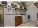 Laundry room with washer, dryer, and extra storage at 33 Camino Real # 303, Howey In The Hills, FL 34737