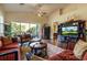 Spacious living room with hardwood floors, large screen TV, and comfortable seating at 33 Camino Real # 303, Howey In The Hills, FL 34737