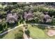 Aerial view of a community with villas near a golf course at 33 Camino Real # 303, Howey In The Hills, FL 34737