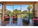 Relaxing screened porch overlooking a lush green landscape at 33 Camino Real # 303, Howey In The Hills, FL 34737