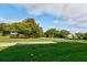 Landscaped community green space with mature trees at 33 Camino Real # 303, Howey In The Hills, FL 34737