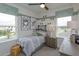 Cozy bedroom with twin bed, nightstand, and window seating at 16388 Hamlin View St, Winter Garden, FL 34787