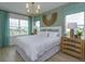 Main bedroom with a king-size bed, neutral decor, and natural light at 16388 Hamlin View St, Winter Garden, FL 34787