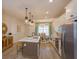 Open concept kitchen with island, stainless steel appliances, and white cabinetry at 16388 Hamlin View St, Winter Garden, FL 34787