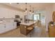 Modern kitchen featuring a center island, stainless steel appliances, and white cabinets at 16388 Hamlin View St, Winter Garden, FL 34787