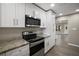 Modern kitchen with stainless steel appliances and granite counters at 1261 W Lakeshore Dr, Clermont, FL 34711