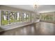 Dining room with hardwood floors and large windows overlooking the lake at 1261 W Lakeshore Dr, Clermont, FL 34711