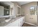 Updated bathroom boasts a double vanity with granite countertop at 1261 W Lakeshore Dr, Clermont, FL 34711