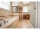 Spa-like bathroom with soaking tub, walk-in shower, and tile flooring at 3554 County Road 216, Oxford, FL 34484