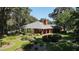 Brick home with landscaped gardens and a large backyard at 3554 County Road 216, Oxford, FL 34484