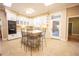 Bright kitchen with white cabinets, island, and tile floors at 3554 County Road 216, Oxford, FL 34484