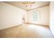 Bright bedroom with carpeted floor and large window at 3554 County Road 216, Oxford, FL 34484