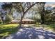 Brick home nestled on a spacious lot with mature trees and a long driveway at 3554 County Road 216, Oxford, FL 34484