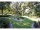 Landscaped yard with mature trees and lush greenery at 3554 County Road 216, Oxford, FL 34484