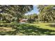 Home situated on a large lot with circular driveway and lush landscaping at 3554 County Road 216, Oxford, FL 34484