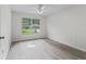 Well-lit bedroom with ceiling fan and large window at 102 Costa Mesa Dr, The Villages, FL 32159