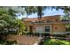 Beautiful two-story home with a tile roof and lush landscaping at 23 Camino Real Blvd # 23, Howey In The Hills, FL 34737
