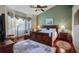 Spacious bedroom with hardwood floors, large windows, and a ceiling fan at 23 Camino Real Blvd # 23, Howey In The Hills, FL 34737