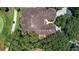 Aerial view of a home with tile roof, surrounded by lush greenery at 23 Camino Real Blvd # 23, Howey In The Hills, FL 34737