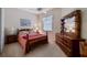 Bright bedroom with double bed and wood dresser at 23 Camino Real Blvd # 23, Howey In The Hills, FL 34737