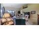 Bright living room with vaulted ceilings, comfy seating, and access to a balcony overlooking a golf course at 23 Camino Real Blvd # 23, Howey In The Hills, FL 34737