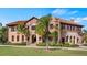 Two-story Mediterranean style home with palm trees and manicured lawn at 23 Camino Real Blvd # 23, Howey In The Hills, FL 34737