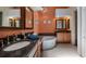 Elegant bathroom with a large soaking tub, dual vanities, and upgraded fixtures at 23 Camino Real Blvd # 23, Howey In The Hills, FL 34737