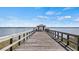 Wooden pier extending into a lake with a gazebo at the end at 23 Camino Real Blvd # 23, Howey In The Hills, FL 34737