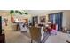 Open concept living room with a partial kitchen view and comfortable seating at 23 Camino Real Blvd # 23, Howey In The Hills, FL 34737