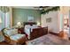 Spacious bedroom with wood flooring, a king-size bed, and a sitting area at 23 Camino Real Blvd # 23, Howey In The Hills, FL 34737