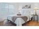 Guest bedroom with wood floors, a queen bed, and artwork above the bed at 1405 W Schwartz Blvd, The Villages, FL 32159